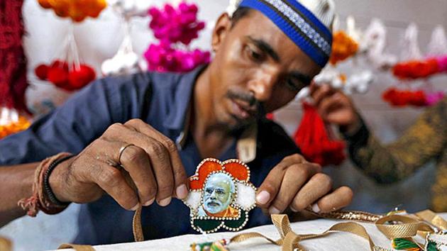 A Muslim artisan displays a "Rakhi" featuring India's Prime Minister Narendra Modi after giving it the finishing touches inside a workshop in Ahmedabad. (Reuters file photo) A Muslim artisan displays a "Rakhi" featuring India's Prime Minister Narendra Modi after giving it the finishing touches inside a workshop in Ahmedabad. (Reuters file photo)