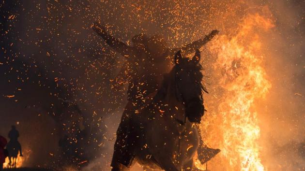 A horseman jumps over a bonfire...all fire and heat. (AFP) A horseman jumps over a bonfire...all fire and heat. (AFP)