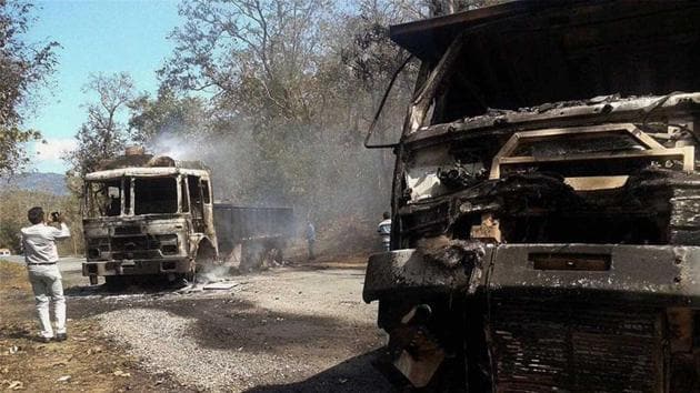 A police official records vehicles burnt by Maoists in Sukma district of Chhattisgarh in this undated photo.(PTI file photo)