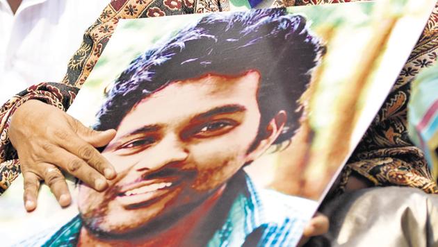 Rohith Vemula's mother Radhika (not visible) holds his photo during a protest at Jantar Mantar in New Delhi.(Arun Sharma/HT File Photo)