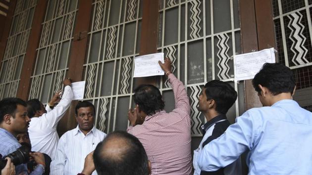 There was some resistance by the occupants, but officials from the collector’s office finally took possession and sealed the property. (kunal patil/ht photo) There was some resistance by the occupants, but officials from the collector’s office finally took possession and sealed the property. (kunal patil/ht photo)