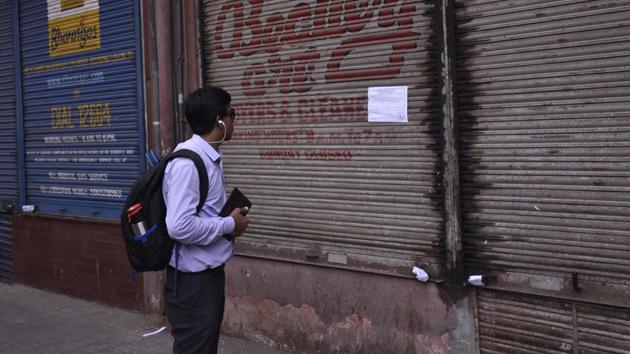 A passerby reads the collector’s notice on building that houses Eros Cinema on Wednesday. Shows at the theater, too, have been abruptly stopped. (kunal patil/ht photo) A passerby reads the collector’s notice on building that houses Eros Cinema on Wednesday. Shows at the theater, too, have been abruptly stopped. (kunal patil/ht photo)