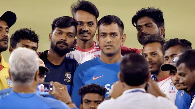 Mahendra Singh Dhoni with local bowlers at a practice session at Barabati Stadium in Cuttack. (PTI)
