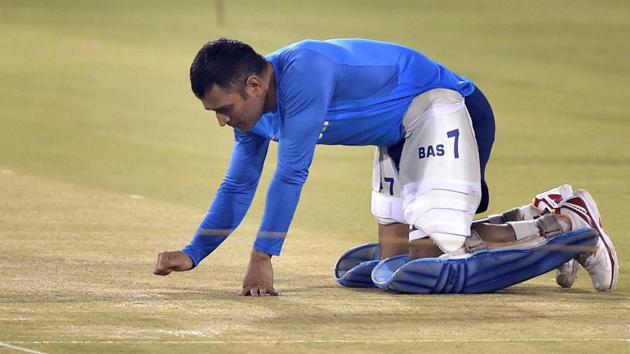 Mahendra Singh Dhoni inspects the pitch at Barabati Stadium in Cuttack on Wednesday. (PTI)