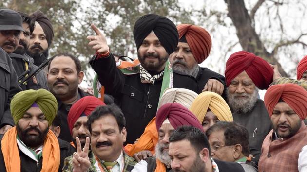 Navjot Singh Sidhu with other Congress leaders during a road show in Amritsar on Tuesday.(Gurpreet Singh/HT Photo)