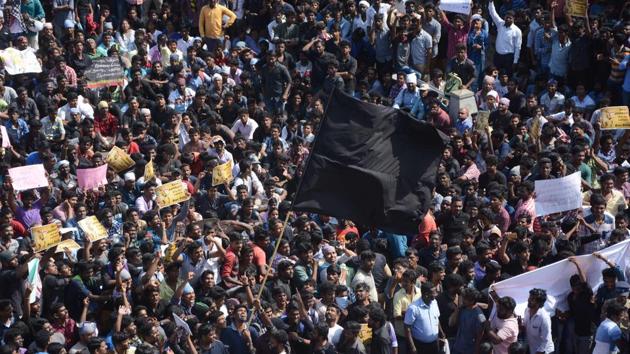 Protesters wave black flags as the support for Jallikattu gathered momentum after a major rally at Marina Beach at Chennai on Wednesday. (AFP) Protesters wave black flags as the support for Jallikattu gathered momentum after a major rally at Marina Beach at Chennai on Wednesday. (AFP)