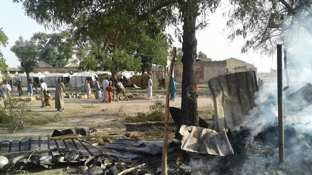 This hand-out image received in courtesy of Doctors Without Border (MSF) on January 17, 2017, shows people standing next to the destruction after an air force jet accidentally bombarded a camp for those displaced by Boko Haram Islamists, in Rann, northeast Nigeria. At least 100 aid workers and civilians were killed. (AFP PHOTO / Médecins sans Frontières (MSF) / Handout) This hand-out image received in courtesy of Doctors Without Border (MSF) on January 17, 2017, shows people standing next to the destruction after an air force jet accidentally bombarded a camp for those displaced by Boko Haram Islamists, in Rann, northeast Nigeria. At least 100 aid workers and civilians were killed. (AFP PHOTO / Médecins sans Frontières (MSF) / Handout)