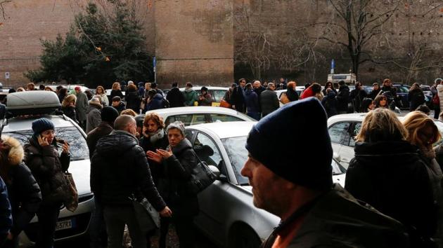 People stand on the road after leaving buildings following an earthquake in Rome on Wednesday. (REUTERS) People stand on the road after leaving buildings following an earthquake in Rome on Wednesday. (REUTERS)