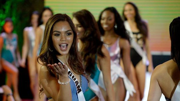 Miss Guam Muneka Joy Cruz Taisipic blows a kiss during a Miss Universe swimwear fashion show in Cebu City. (AFP) 