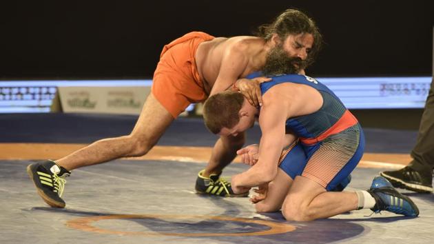 Baba Ramdev displayed his wrestling skills as he went head-to-head with 2008 Olympic silver medalist Andriy Stadnik in a promotional bout of the 2017 Pro Wrestling League (PWL).(Virendra Singh Gosain/HT PHOTO) Baba Ramdev displayed his wrestling skills as he went head-to-head with 2008 Olympic silver medalist Andriy Stadnik in a promotional bout of the 2017 Pro Wrestling League (PWL).(Virendra Singh Gosain/HT PHOTO)