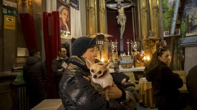 A woman holds her dog in San Anthony's church during the feast of Saint Anthony. (Daniel Ochoa de Olza/AP) A woman holds her dog in San Anthony's church during the feast of Saint Anthony. (Daniel Ochoa de Olza/AP)