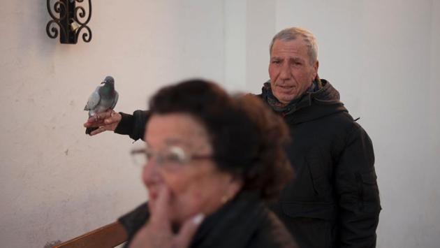 A man holds a dove before having it blessed by a priest in Churriana, near Malaga. (Jorge Guerrero/AFP) A man holds a dove before having it blessed by a priest in Churriana, near Malaga. (Jorge Guerrero/AFP)