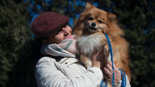 A woman holds her dog as they wait to be blessed by a priest in Mijas on San Anton Abad's Day (Saint Anthony). (JOrge Guerrero/AFP) A woman holds her dog as they wait to be blessed by a priest in Mijas on San Anton Abad's Day (Saint Anthony). (JOrge Guerrero/AFP)