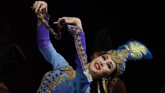 A member of Xinjiang Art Theatre song and Dance troupe performs in a Group dance Flower pattern Waistband. ICEC has taken Indian culture and its finest display to the streets and corridors of great repute in China with the same vigor and zeal as it has promoted Chinese culture in the cities, towns and cultural platforms of great repute in India. (Arvind Yadav/HT PHOTO) A member of Xinjiang Art Theatre song and Dance troupe performs in a Group dance Flower pattern Waistband. ICEC has taken Indian culture and its finest display to the streets and corridors of great repute in China with the same vigor and zeal as it has promoted Chinese culture in the cities, towns and cultural platforms of great repute in India. (Arvind Yadav/HT PHOTO)