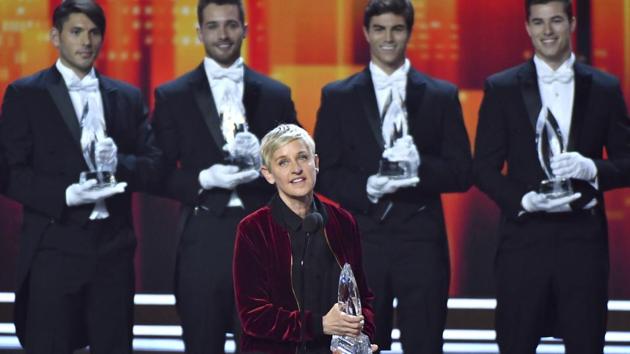 Ellen DeGeneres, winner of the awards for favourite animated movie voice, favourite daytime TV host, and favourite comedic collaboration, speaks on stage at the People's Choice Awards at the Microsoft Theatre in Los Angeles. Pictured in the background are DeGeneres' previous People's Choice awards, making her the most decorated People's Choice Award winner in the show's history. (AP)