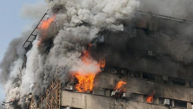 Smoke billows from the high-rise building in Tehran. Dozens of firefighters were feared trapped under the rubble . (REUTERS) Smoke billows from the high-rise building in Tehran. Dozens of firefighters were feared trapped under the rubble . (REUTERS)