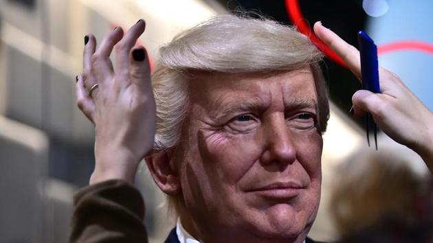 An employee puts the final touches to the waxwork model of US President-elect Donald Trump ahead of its unveiling at the Grevin museum in Paris on January 19, 2017. (AFP) An employee puts the final touches to the waxwork model of US President-elect Donald Trump ahead of its unveiling at the Grevin museum in Paris on January 19, 2017. (AFP)