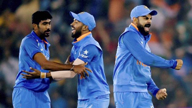 India skipper Virat Kohli reacts as J Bumrah (L) celebrates with Hardik Pandya after dismissing England batsman Alex Hales. (PTI) India skipper Virat Kohli reacts as J Bumrah (L) celebrates with Hardik Pandya after dismissing England batsman Alex Hales. (PTI)