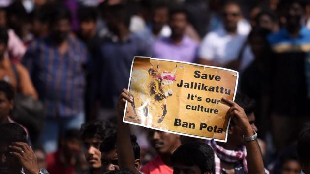 Students shout slogans and hold placards during a demonstration against the ban on Jallikattu, and calling for a ban on animal rights orgnisation PETA, at Marina Beach at Chennai.(AFP Photo)
