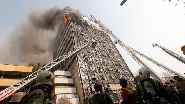 Firefighters battle a blaze that engulfed Iran's oldest high-rise, the 15-storey Plasco building in downtown Tehran. State television said 200 firefighters had been called to the scene and 38 had already been injured battling the blaze before it fell. (AFP) Firefighters battle a blaze that engulfed Iran's oldest high-rise, the 15-storey Plasco building in downtown Tehran. State television said 200 firefighters had been called to the scene and 38 had already been injured battling the blaze before it fell. (AFP)
