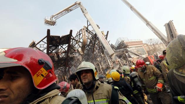 The steel skeleton of the building could be seen bending down to the ground as around 100 fire engines and dozens of ambulances surrounded the area. (AFP) The steel skeleton of the building could be seen bending down to the ground as around 100 fire engines and dozens of ambulances surrounded the area. (AFP)