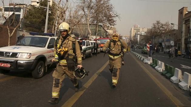 Iranian firefighters run towards the Plasco building engulfed by a fire in central Tehran, Iran. (AP) Iranian firefighters run towards the Plasco building engulfed by a fire in central Tehran, Iran. (AP)