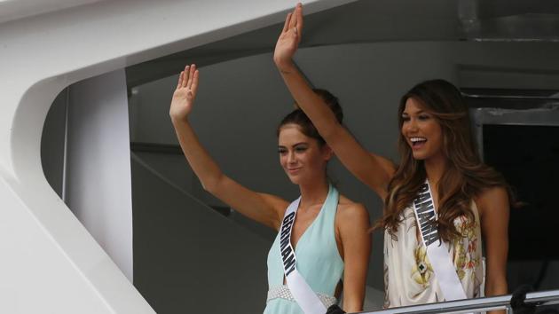 Miss Universe contestants Johanna Acs, left, of Germany, and Keity Drennan of Panama wave from the yacht. (AP) Miss Universe contestants Johanna Acs, left, of Germany, and Keity Drennan of Panama wave from the yacht. (AP)
