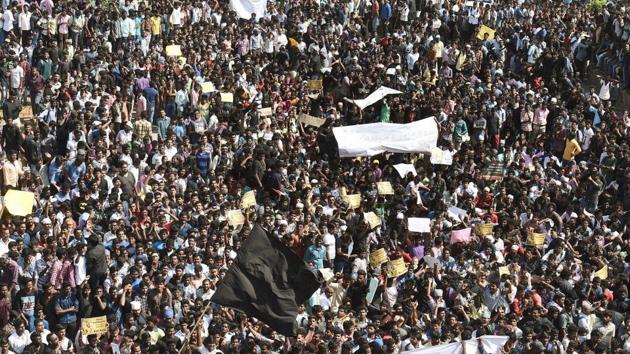 Youngsters and students during a protest to lift the ban on Jallikattu and impose ban on PETA, at Kamarajar Salai, Marina Beach in Chennai on Wednesday.(PTI Photo)