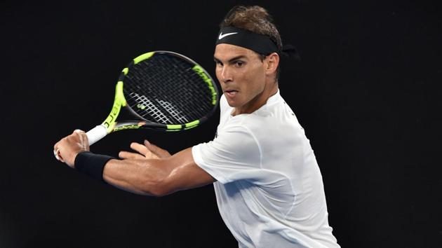 Rafael Nadal hits a return against Cyprus's Marcos Baghdatis during their men's singles second round match. He won 6-3, 6-1, 6-3. (AFP) 