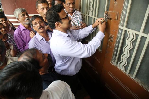 Officials from the collector’s office unseal Eros talkies cinema located in the Cambata building on Thursday(Anshuman Poyrekar) Officials from the collector’s office unseal Eros talkies cinema located in the Cambata building on Thursday(Anshuman Poyrekar)