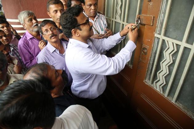 Officials from the collector’s office unseal Eros talkies cinema located in the Cambata building on Thursday(Anshuman Poyrekar)