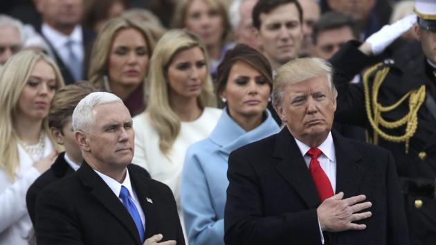 US President Donald Trump (R) and vice president Mike Pence stand for the singing of the US national anthem during their inauguration ceremony at the US Capitol in Washington. (REUTERS) US President Donald Trump (R) and vice president Mike Pence stand for the singing of the US national anthem during their inauguration ceremony at the US Capitol in Washington. (REUTERS)