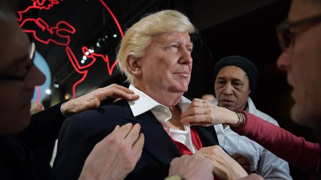 Employees put the final touches to the waxwork model of US President-elect Donald Trump ahead of its unveiling at the Grevin museum in Paris on January 19, 2017. (AFP) Employees put the final touches to the waxwork model of US President-elect Donald Trump ahead of its unveiling at the Grevin museum in Paris on January 19, 2017. (AFP)