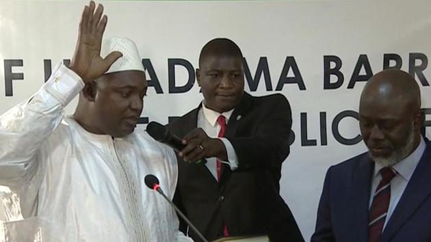 Adama Barrow, left, is sworn in as President of Gambia at Gambia's embassy in Dakar Senegal in this image taken from TV Thursday, Jan 19, 2017. (AP) Adama Barrow, left, is sworn in as President of Gambia at Gambia's embassy in Dakar Senegal in this image taken from TV Thursday, Jan 19, 2017. (AP)
