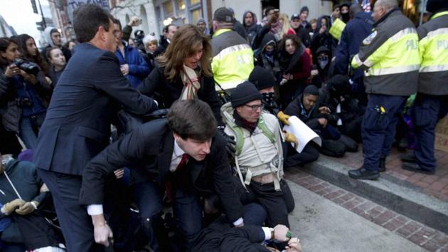 Inaugural attendees move through demonstrators attempting to block people entering a security checkpoint, on Friday, ahead of President-elect Donald Trump's inauguration in Washington. (AP) Inaugural attendees move through demonstrators attempting to block people entering a security checkpoint, on Friday, ahead of President-elect Donald Trump's inauguration in Washington. (AP)