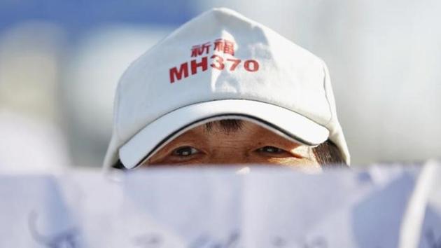 A family member of a passenger aboard Malaysia Airlines flight MH370, which went missing in 2014, reacts during a protest outside the Chinese foreign ministry in Beijing on July 29, 2016. The hat reads “Pray for MH370”. (Reuters) A family member of a passenger aboard Malaysia Airlines flight MH370, which went missing in 2014, reacts during a protest outside the Chinese foreign ministry in Beijing on July 29, 2016. The hat reads “Pray for MH370”. (Reuters)