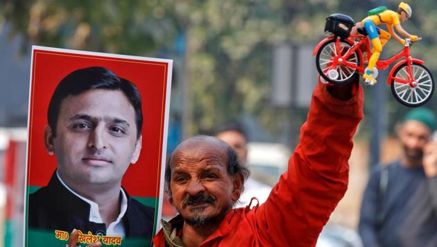A Samajwadi Party worker holds a bicycle representing the party's symbol and a poster of chief minister Akhilesh Yadav, outside the party's headquarters in Lucknow.(REUTERS FILE) A Samajwadi Party worker holds a bicycle representing the party's symbol and a poster of chief minister Akhilesh Yadav, outside the party's headquarters in Lucknow.(REUTERS FILE)