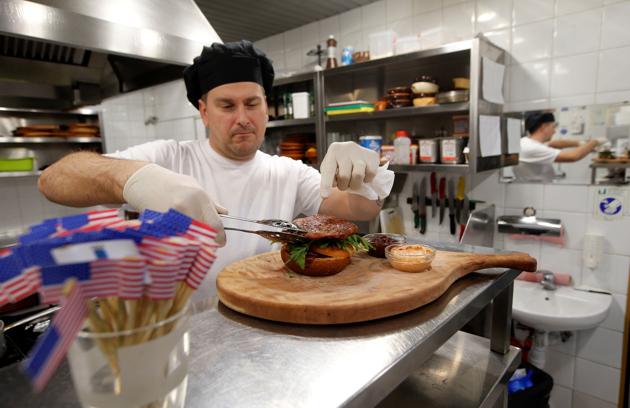 Chef Elvis Suhodoljac prepares a burger named President's burger in Melania Trump's hometown of Sevnica, Slovenia January 20, 2017. (REUTERS) Chef Elvis Suhodoljac prepares a burger named President's burger in Melania Trump's hometown of Sevnica, Slovenia January 20, 2017. (REUTERS)