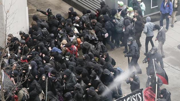 Police use pepper spray on protesters in Washington in a chaotic confrontation blocks from Donald Trump's inauguration. (AP) Police use pepper spray on protesters in Washington in a chaotic confrontation blocks from Donald Trump's inauguration. (AP)