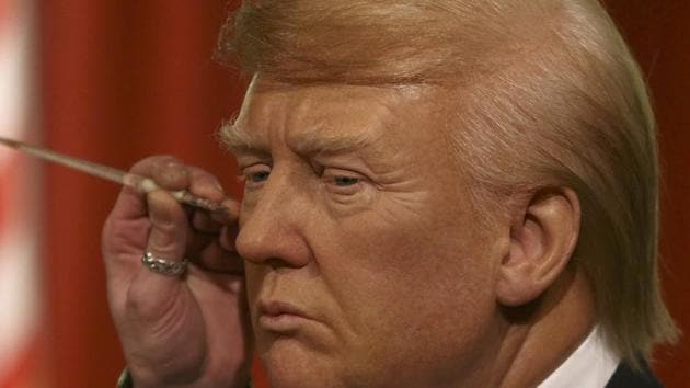 A gallery assistants poses, pretending to put the finishing touches to the hair and make-up of the waxwork in London. (Neil Hall/ REUTERS) A gallery assistants poses, pretending to put the finishing touches to the hair and make-up of the waxwork in London. (Neil Hall/ REUTERS)