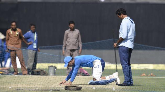 Mahendra Singh Dhoni inspecting the pitch at Eden Gardens in Kolkata. (HT Photo/subhankar chakraborty )