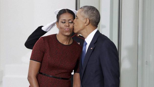 President Barack Obama kisses first lady Michelle Obama as they await for the arrival of President-elect Donald Trump and his wife Melania on Friday at the White House in Washington. (AP Photo) President Barack Obama kisses first lady Michelle Obama as they await for the arrival of President-elect Donald Trump and his wife Melania on Friday at the White House in Washington. (AP Photo)