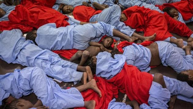 In this January 13, 2017 photo, Idris 3, from Mali, center, sleeps next to his mother Aicha Keita, right, on the deck of the Golfo Azzurro vessel after being rescued from the Mediterranean sea, about 20 miles north of Ra's Tajura, Libya. Spain's maritime rescue service says the bodies of seven African migrants have been found dead along the Strait of Gibraltar since Friday. (Olmo Calvo/AP) In this January 13, 2017 photo, Idris 3, from Mali, center, sleeps next to his mother Aicha Keita, right, on the deck of the Golfo Azzurro vessel after being rescued from the Mediterranean sea, about 20 miles north of Ra's Tajura, Libya. Spain's maritime rescue service says the bodies of seven African migrants have been found dead along the Strait of Gibraltar since Friday. (Olmo Calvo/AP)