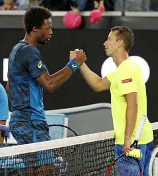 Gael Monfils (left) is congratulated by Germany's Philipp Kohlschreiber. Monfils won the Rd 3 match 6-3, 7-6 (7/1), 6-4. (AP)