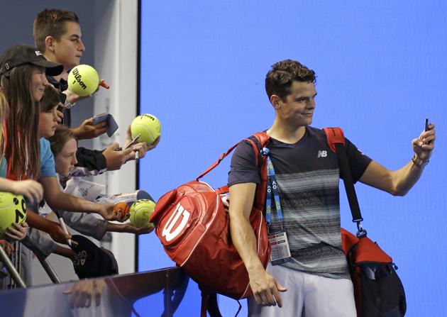 Milos Raonic takes a selfie for a fan after defeating France's Gilles Simon 6-2, 7-6 (7/5), 3-6, 6-3. (AP)