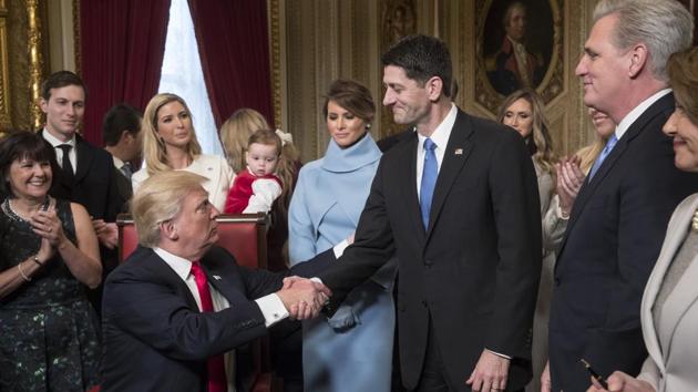 President Donald Trump turns to House Speaker Paul Ryan as he is joined by the Congressional leadership and his family , in the President's Room of the Senate, at the Capitol in Washington.(AP)