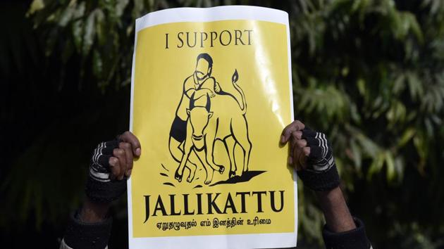 A Jallikattu supporter holds a placard during a protest march against the Supreme Court ban, at the Jantar Mantar in New Delhi on Thursday.(Ravi Choudhary/HT PHOTO)