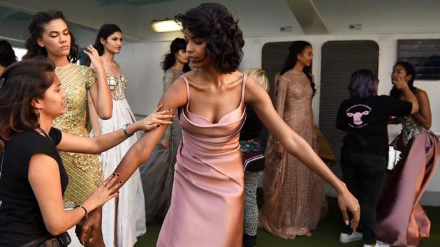 Models getting ready backstage during the show. (PTI) Models getting ready backstage during the show. (PTI)