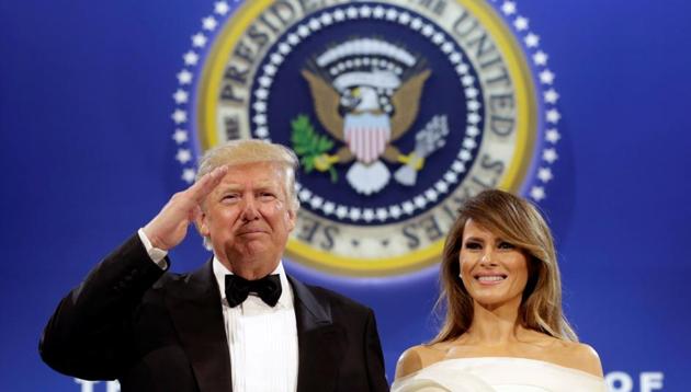 US President Donald Trump salutes with his wife Melania at the Armed Services Ball in Washington on Friday. (REUTERS) US President Donald Trump salutes with his wife Melania at the Armed Services Ball in Washington on Friday. (REUTERS)