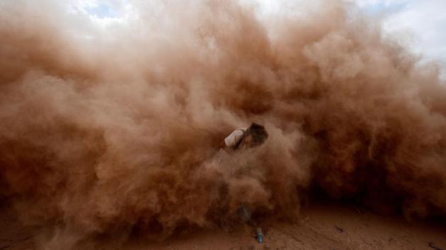 A photographer is pictured during Stage 11 of the 2017 Dakar Rally between San Juan and Rio Cuarto, in Argentina. (Franck Fife/AFP) A photographer is pictured during Stage 11 of the 2017 Dakar Rally between San Juan and Rio Cuarto, in Argentina. (Franck Fife/AFP)